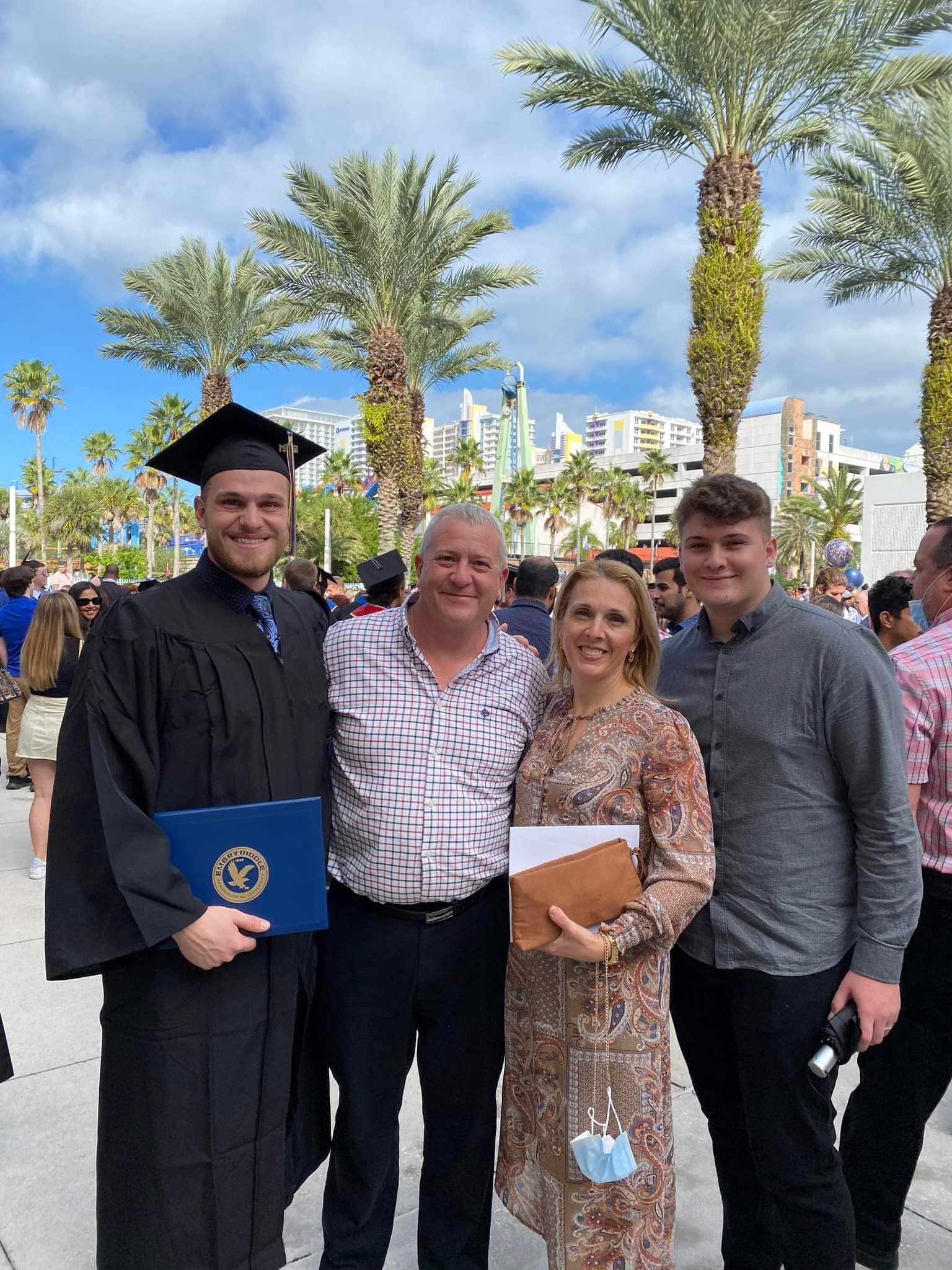 Family poses together after graduation ceremony.