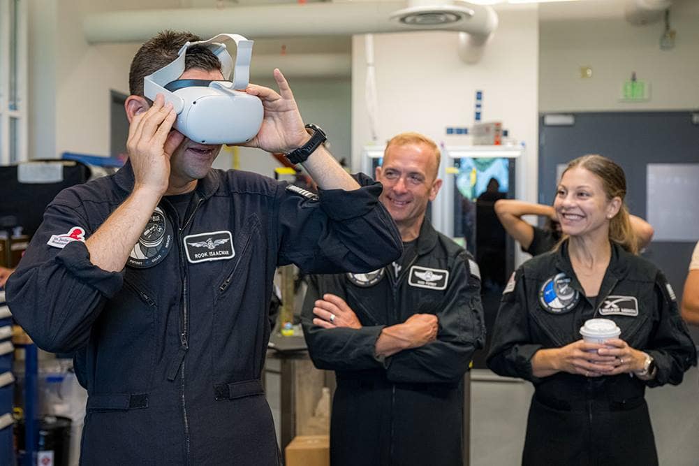 Polaris Dawn Mission Commander Jared Isaacman looks through a virtual reality headset to see test footage from the LLAMAS camera unit.