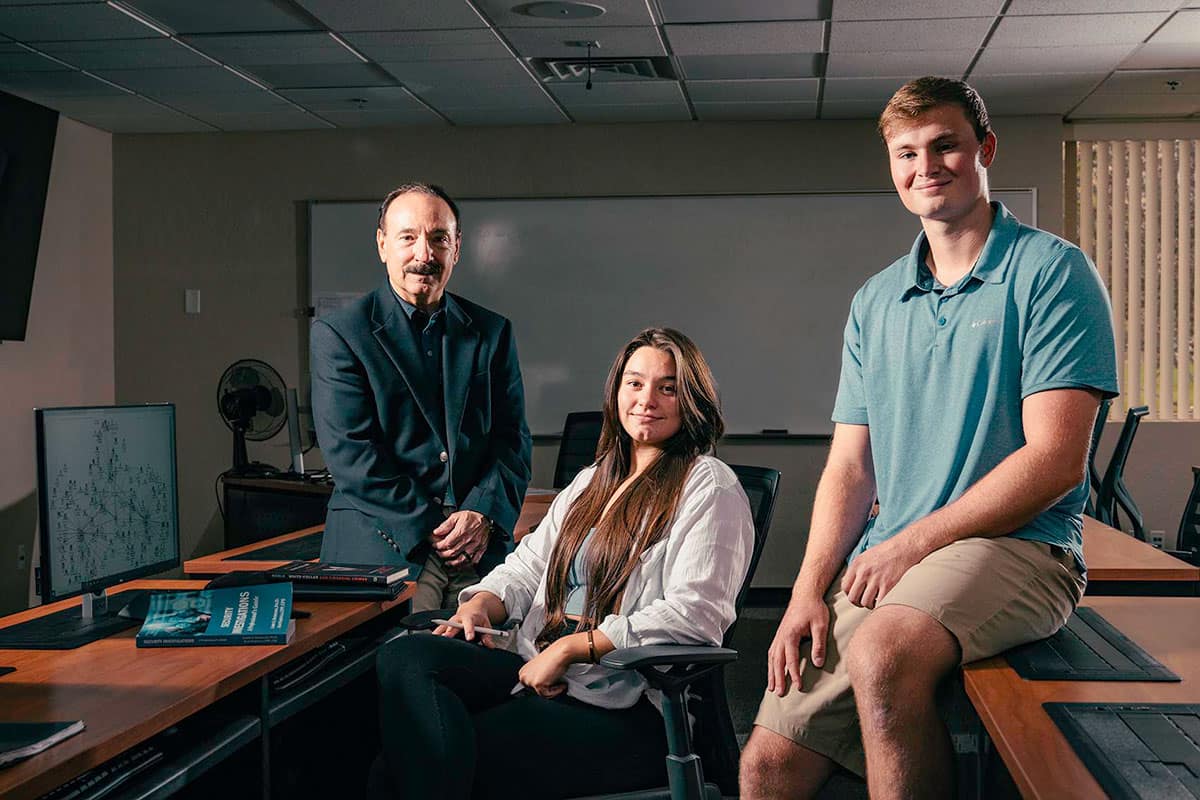 Alan Saquella, instructor of Global Security and Intelligence, with students Hannah Hoffman and Cade Cabral.