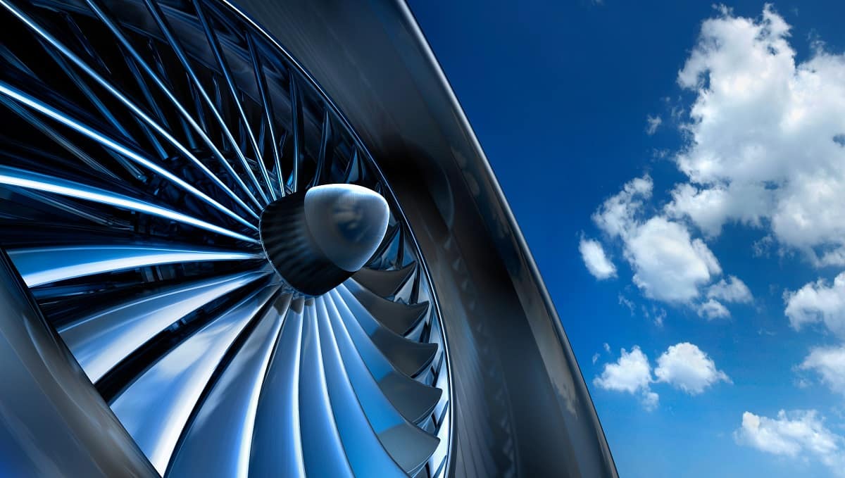 Jet engine in front of blue sky.