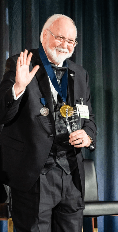 Man accepts award on stage.