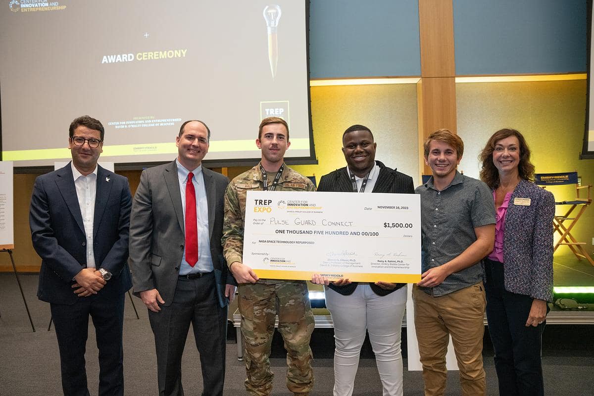 Six people hold large check.