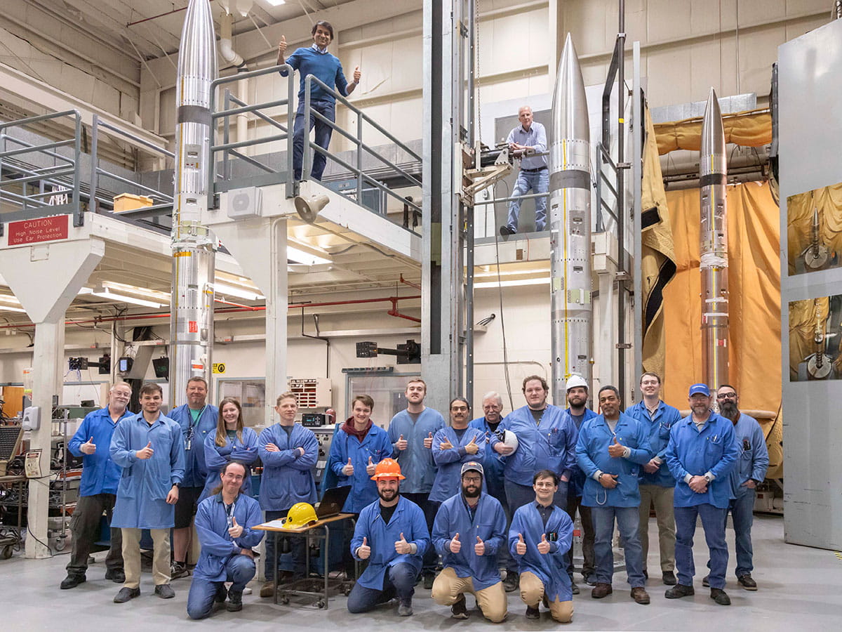NASA and Embry‑Riddle researchers recently posed with three sounding rockets that are part of the APEP (Atmospheric Perturbations around Eclipse Path) mission. Lead researcher Dr. Aroh Barjatya is at the top left. (Photo: NASA/Berit Bland)