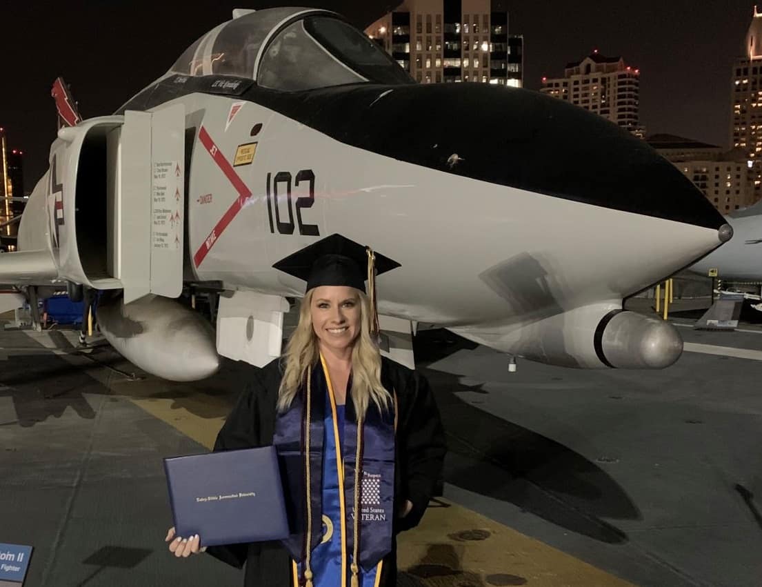 Brittany Hollinshead, a U.S. Army veteran who works in safety management at a major airline, credits Embry‑Riddle with helping her achieve her career goals. She is shown here at her undergraduate commencement ceremony aboard the USS Midway in San Diego, California. Next, she’ll be pursuing her master’s degree. (Photo: Brittany Hollinshead)