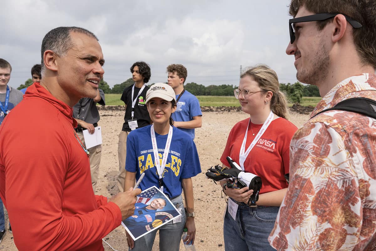 Embry-Riddle students show NASA astronaut Anil Menon (left) a spacesuit glove prototype that was part of their winning project at the NASA Artemis Student Challenge. (Photo: NASA/James Blair)