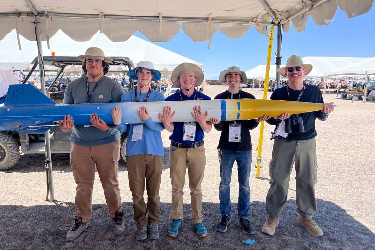 Students of the Rocket Development Lab (RDL) team holding their rocket with their faculty advisor, professor Mark Benton, at the 2024 Spaceport America Cup near Las Cruces, New Mexico. (Photo: Dave Teague)