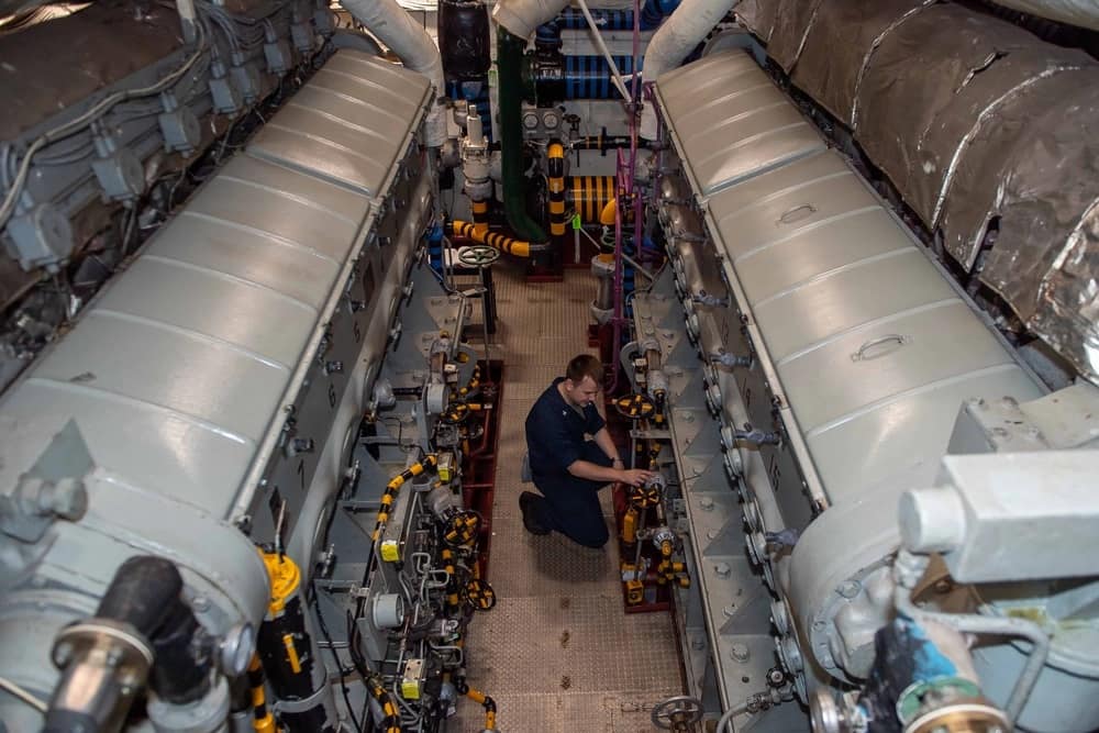 A U.S. Navy sailor inspects an engineering space aboard the Nimitz-class aircraft carrier USS Theodore Roosevelt. (Photo: U.S. Navy photo by Mass Communication Specialist Seaman Aaron Haro Gonzalez)