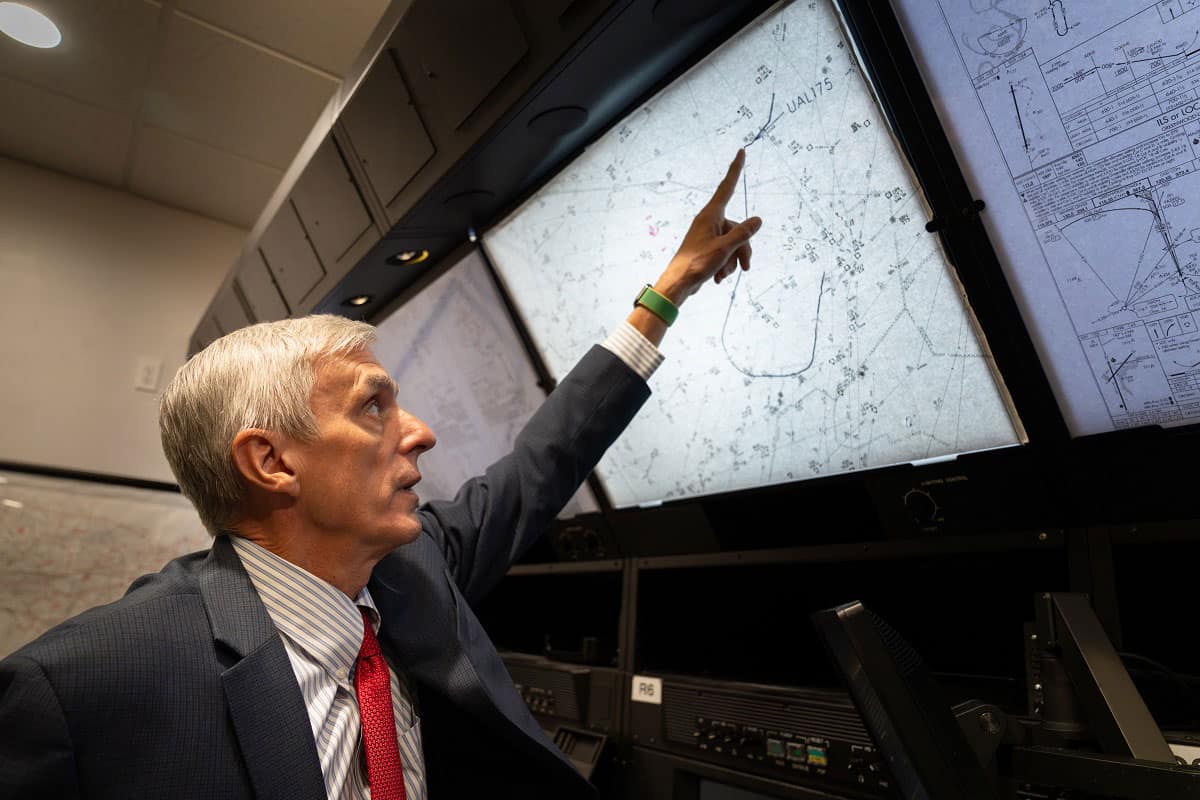 Serving as the FAA’s Air Traffic Manager, New York Center, on Sept. 11, 2001, Dr. Mike McCormick personally made the call to shut down New York City airspace after the attacks on the World Trade Center. Here, he reviews flight path charts from that fateful day. (Photo: Embry‑Riddle/Bernard Wilchuski)