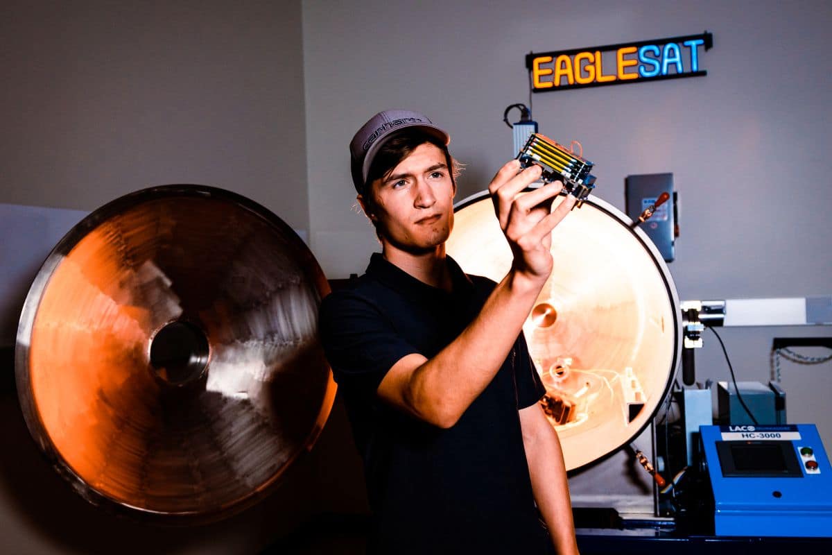 In this year’s U.S. News & World Report rankings, Embry‑Riddle’s Prescott campus earned five top-five distinctions, including No. 1 nationally in the Best Undergraduate Aerospace Engineering Programs category for schools without a Ph.D. option. Here, a student holds a cube satellite (CubeSat) designed, developed and tested by students at Embry‑Riddle’s College of Engineering. (Photo: Embry‑Riddle/Connor McShane)