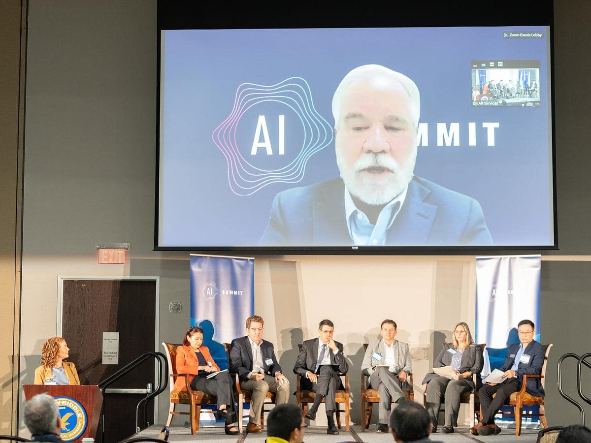 Embry‑Riddle’s inaugural AI Summit featured panels that included faculty and staff from the Daytona Beach, Prescott and Worldwide campuses. Here, Dr. Jon Haass, professor of Cyber Intelligence and Security, speaks to participants via an online feed. (Photo: Embry‑Riddle / David Massey)