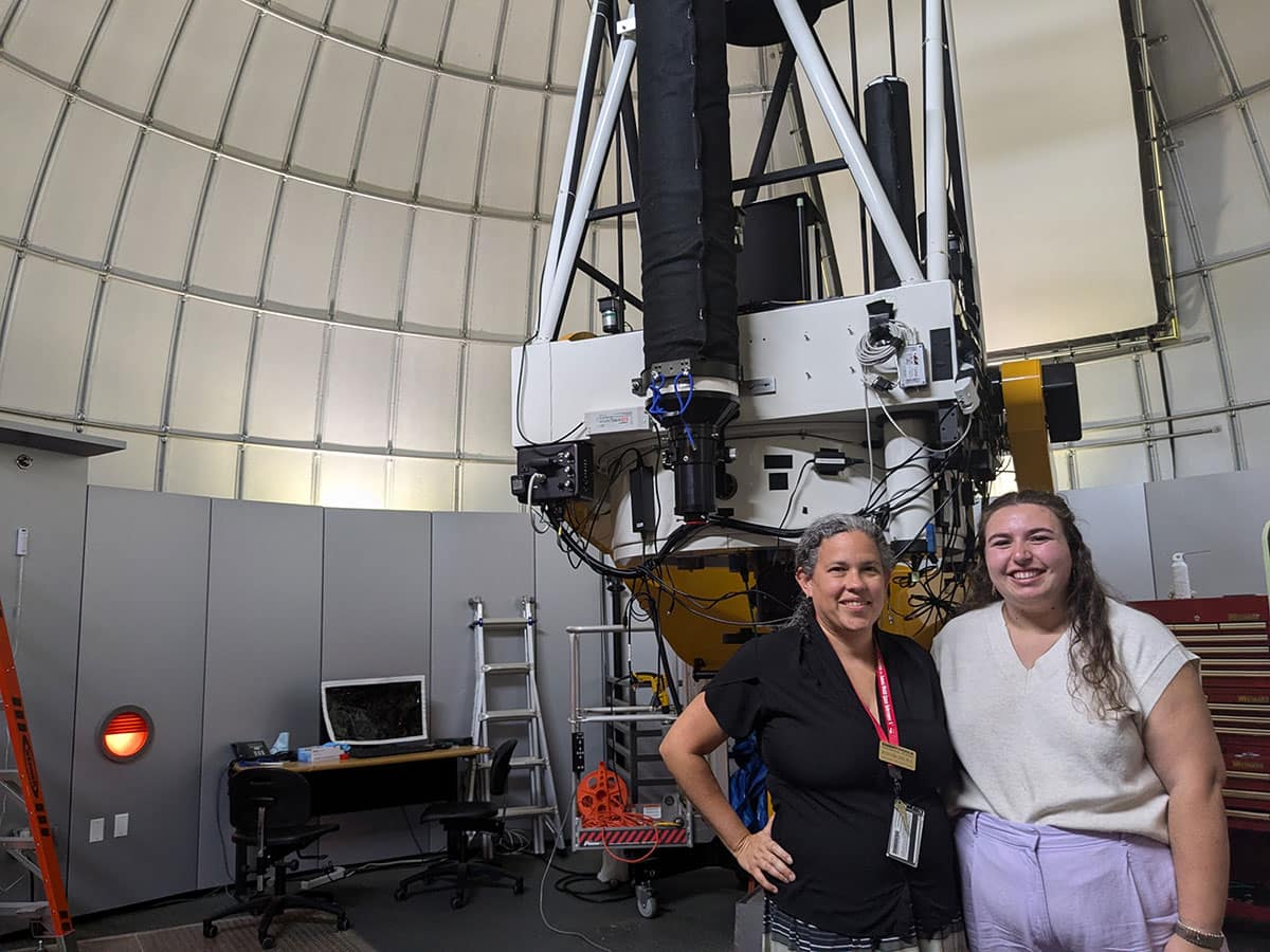 Professor Saida Caballero-Nieves (left) and NASA FINESST awardee Erin Abraham are pictured in front of Embry‑Riddle's one-meter telescope on the Daytona Beach Campus. (Photo: Embry‑Riddle/Erin Abraham)