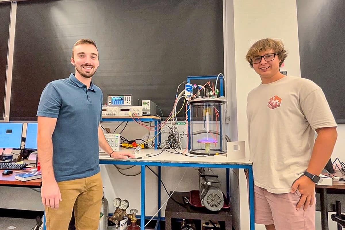 Engineering Physics students Jared Nelson (left) and Seth Gerow are using a Dusty Plasma Chamber at Embry‑Riddle’s SAIL Lab to measure the exact conditions necessary for the initiation of lightning. (Photo: Embry‑Riddle/SAIL Lab)