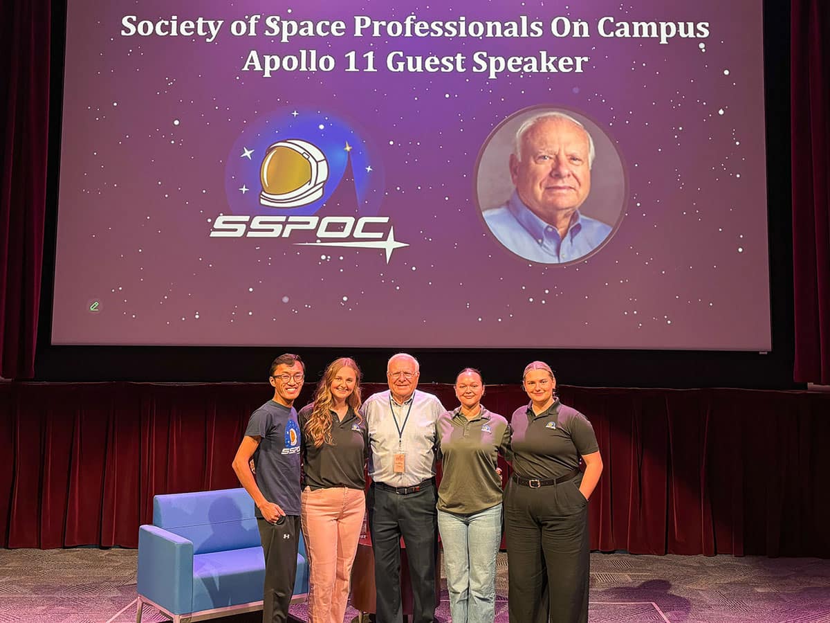 Members of Embry‑Riddle’s Society of Space Professionals on Campus (SSPOC) pose with Apollo 11 flight controller Bob Nance. The students (from left to right) are students Christian Villanueva, Abigail Threatt, Isabel LaCoss and Emily Blackburn. (Photo: Embry‑Riddle/Christian Villanueva)
