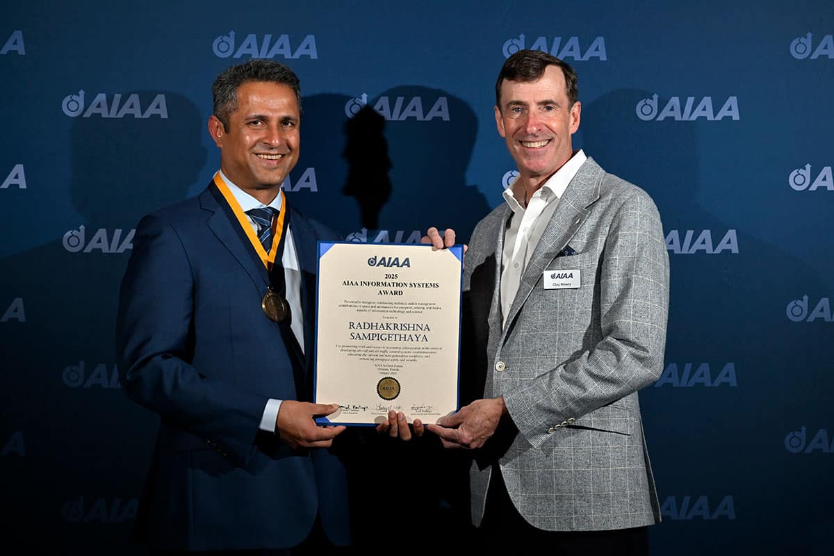 Dr. Krishna Sampigethaya, professor and chair of Embry‑Riddle’s Department of Cyber Intelligence and Security, has been named the 2025 AIAA Information Systems Award recipient. Here, Sampigethaya (left) holds the award alongside AIAA CEO Clay Mowry. (Photo: AIAA)