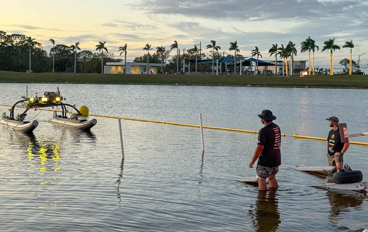 Embry‑Riddle students Sarthak Aggarwal (left) and Erik Liebergall observe the operation of their robotic water vehicle at the 2024 Maritime RobotX Challenge in Sarasota, Florida. (Photo: Embry‑Riddle/Eric Coyle)