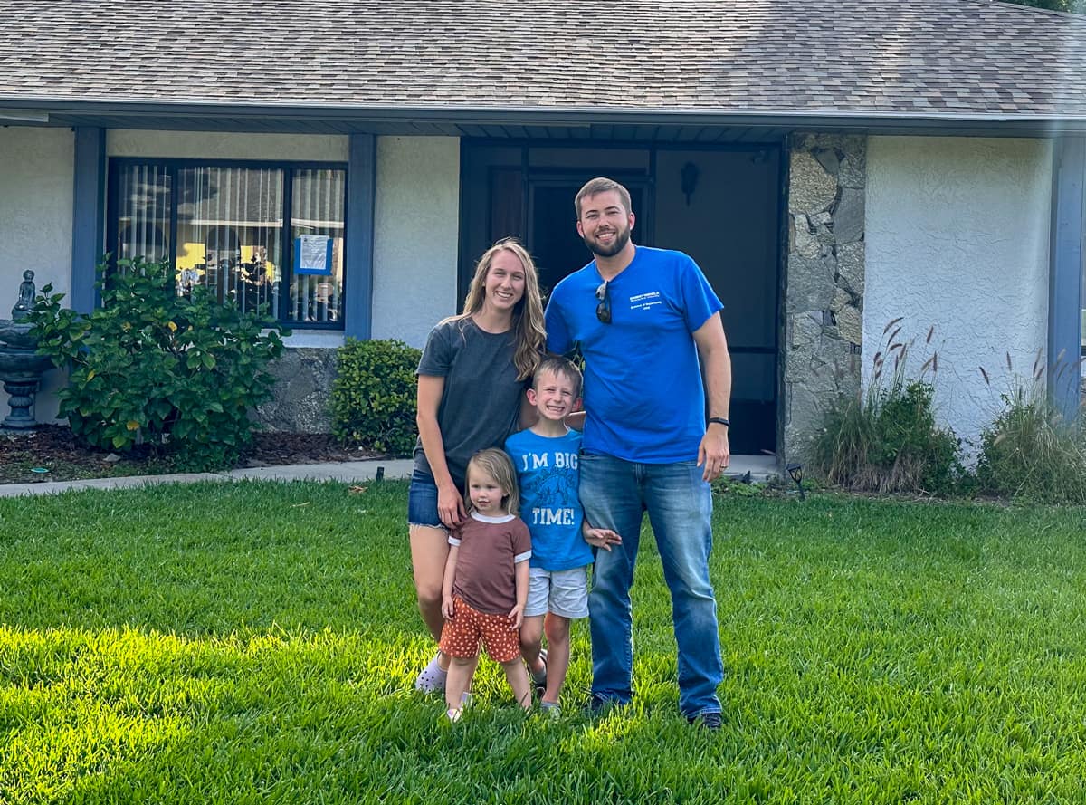 NASA Pathways intern Noah Pointer, a sophomore at Embry‑Riddle Aeronautical University, poses with his wife and two children in front of their home in Florida. (Photo: Noah Pointer)