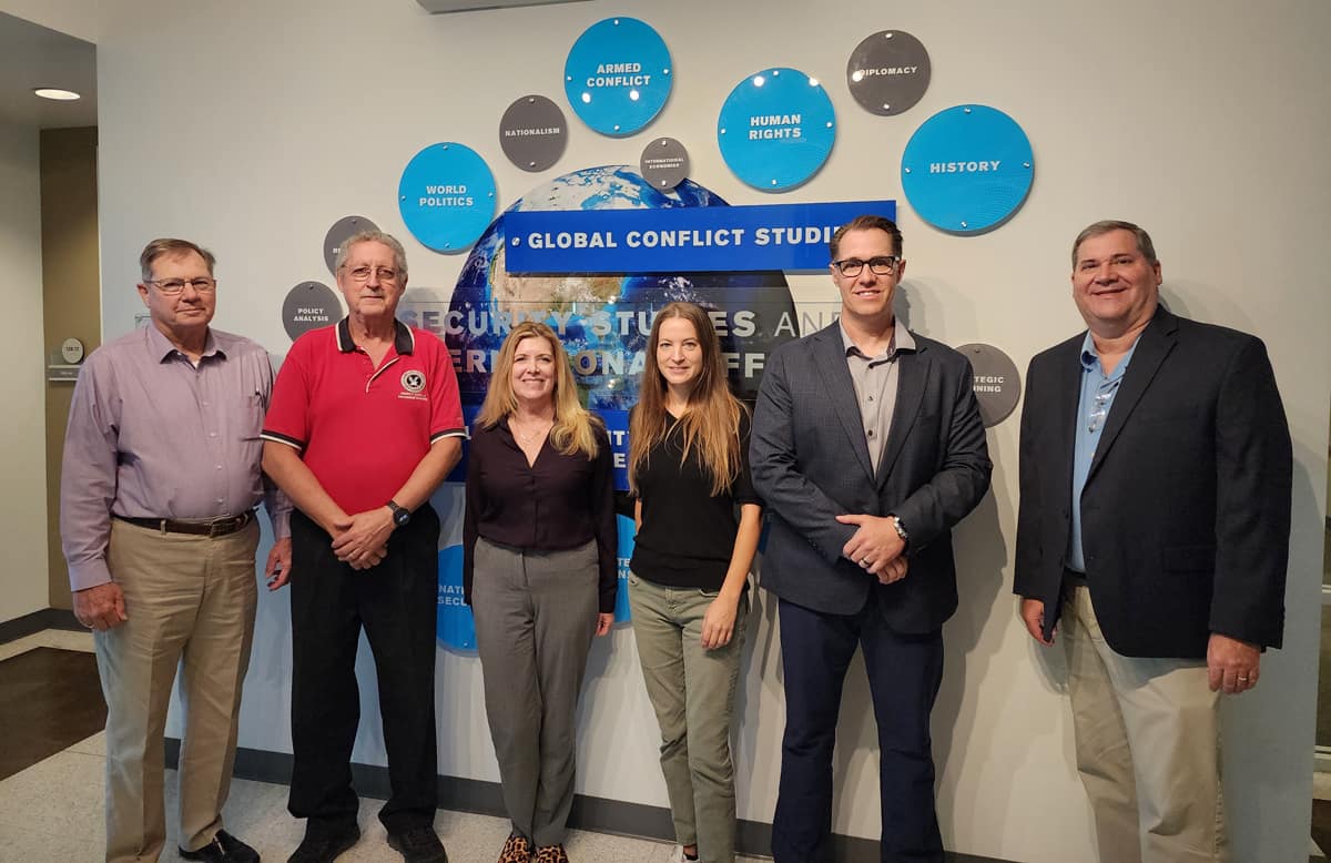 Embry‑Riddle faculty join Council for the Accreditation of Emergency Management and Homeland Security Education representatives outside the university’s Department of Security Studies and International Affairs. Pictured from left to right are: Dr. Larry Porter, CAEMHSE president; Dr. Daniel Cutrer, associate professor; Ann Phillips, J.D., associate department chair; Dr. Bethany Swindell, CAEMHSE auditor; Dr. Jamie Gauthier, CAEMHSE auditor; and Dr. Stephen Craft, department chair. (Photo: Embry Riddle)