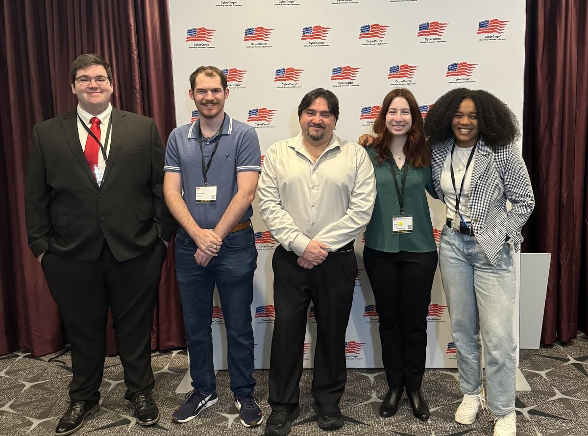 Dr. Omar Ochoa and four students from Embry‑Riddle's Daytona Beach Campus attended the CyberCorps job fair and networking event. Pictured from left to right are Caleb Hall, John-Patrick Mueller, Ochoa, Sofia Guida and Calla Robison (Photo: Embry‑Riddle/Calla Robison)