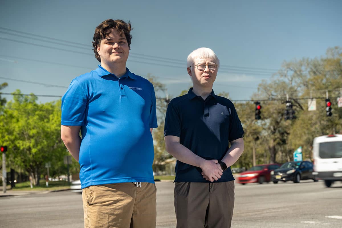 Embry‑Riddle graduate student Marc Jacquet and Dr. Yongxin Liu, assistant professor of Data Science, stand near the intersection of Richard Petty and Clyde Morris boulevards. The intersection was part of innovative research by Jacquet and Liu, which applied AI to study the impacts of cyberthreats to traffic management systems. (Photo: Embry‑Riddle/David Massey)
