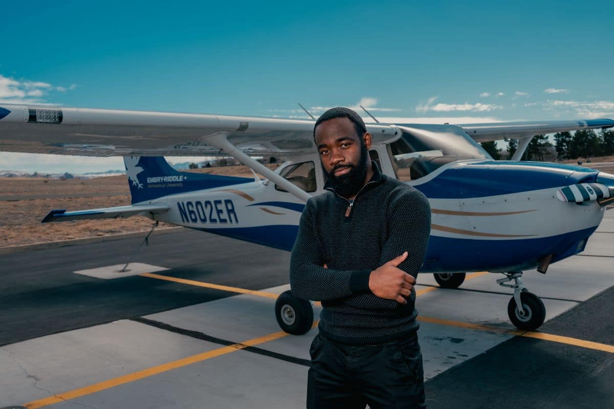 Embry‑Riddle student MicHalifax “Mike” Wanyeki stands beside a Cessna aircraft at the Prescott Campus Flight Line. (Photo: Embry‑Riddle / Connor McShane)