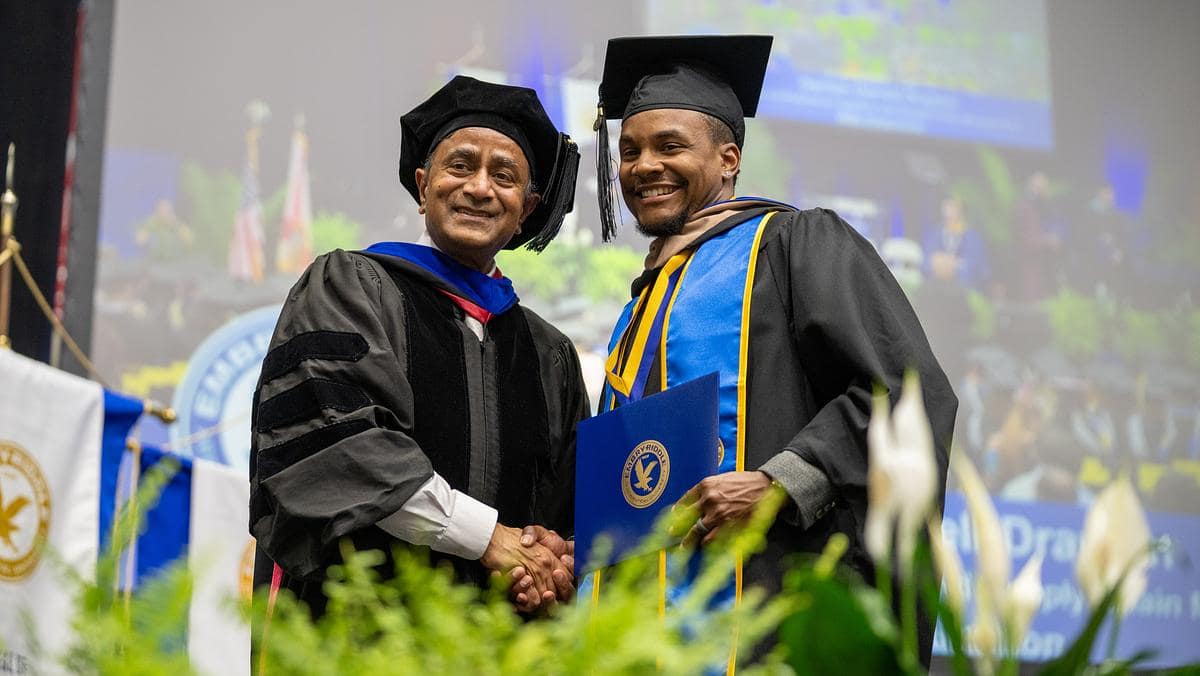 A student celebrates during Embry‑Riddle Aeronautical University’s Worldwide Campus graduate hooding ceremony in 2023. (Photo: Embry‑Riddle/David Massey)