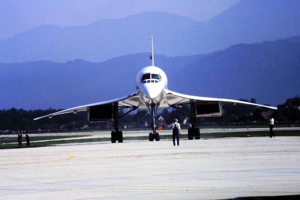 The Concorde at a stop on a runway, pointing directly at the viewer.