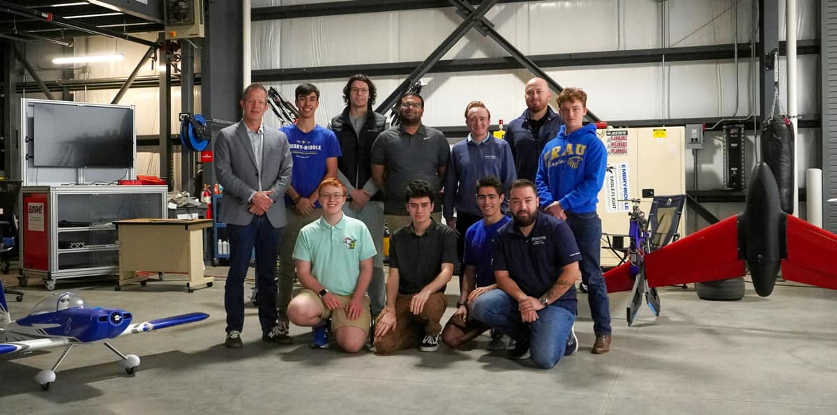 An Embry‑Riddle student team is building a compact emergency response aircraft for the GoAERO competition. Here, the team, along with Dr. Kyle Collins (far left), stands in the Eagle Flight Research Center hangar. (Photo: Patric Hruswicki/Embry‑Riddle)