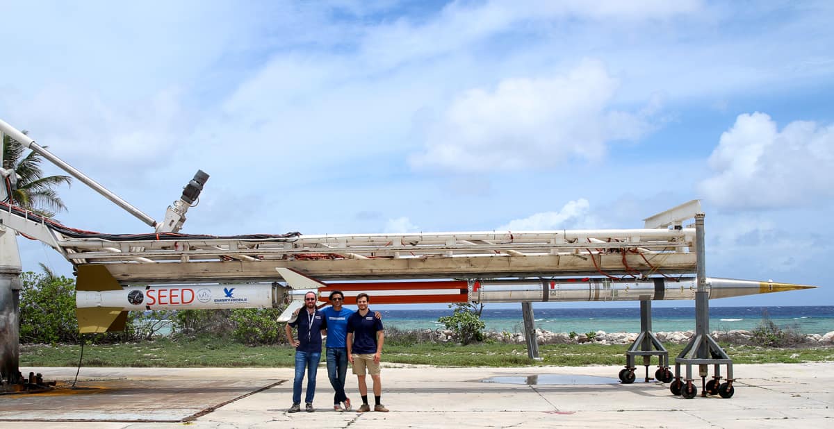 Dr. Robert Clayton, Dr. Aroh Barjatya, and Nathan Graves (left to right) in front of one of the SEED rockets mounted on the launch rail. (Photo: Chris Lanier/NASA) 