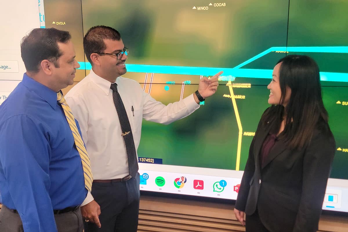 An Embry‑Riddle research team has authored a paper on the integration of Advanced Air Mobility aircraft at Orlando International Airport in Florida. Here, research team members Carlos Castro Peña, Dr. Victor Fraticelli Rivera and Sakurako Kuba examine a mock-up of departure/arrival corridors. (Photo: Embry‑Riddle/Dr. Robert Thomas)