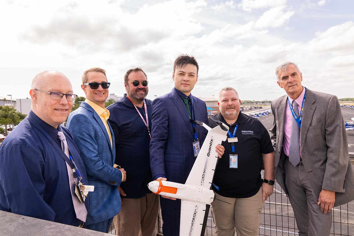 Embry‑Riddle researchers, led by Dr. Chuyang Yang (center), are helping develop training to better incorporate drones into emergency response. The drone pictured takes off vertically, transitions to horizontal flight and has remote sensing capabilities. (Photo: Embry‑Riddle/Bernard Wilchusky)