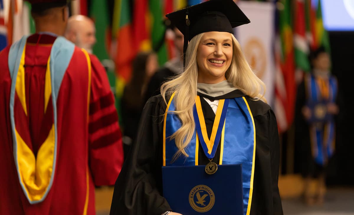 One of the more than 450 Embry‑Riddle Worldwide Campus graduates receives her diploma at a May 31 commencement ceremony held at the ICI Center on the Daytona Beach, Florida, campus. (Photo: Embry‑Riddle/Bernard Wilchusky)
