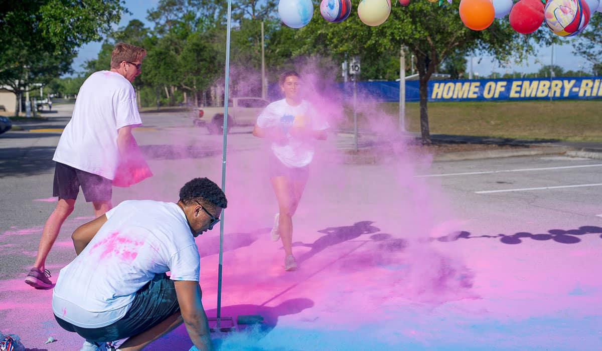 A student participates in Eta Iota’s annual 5K color run.
