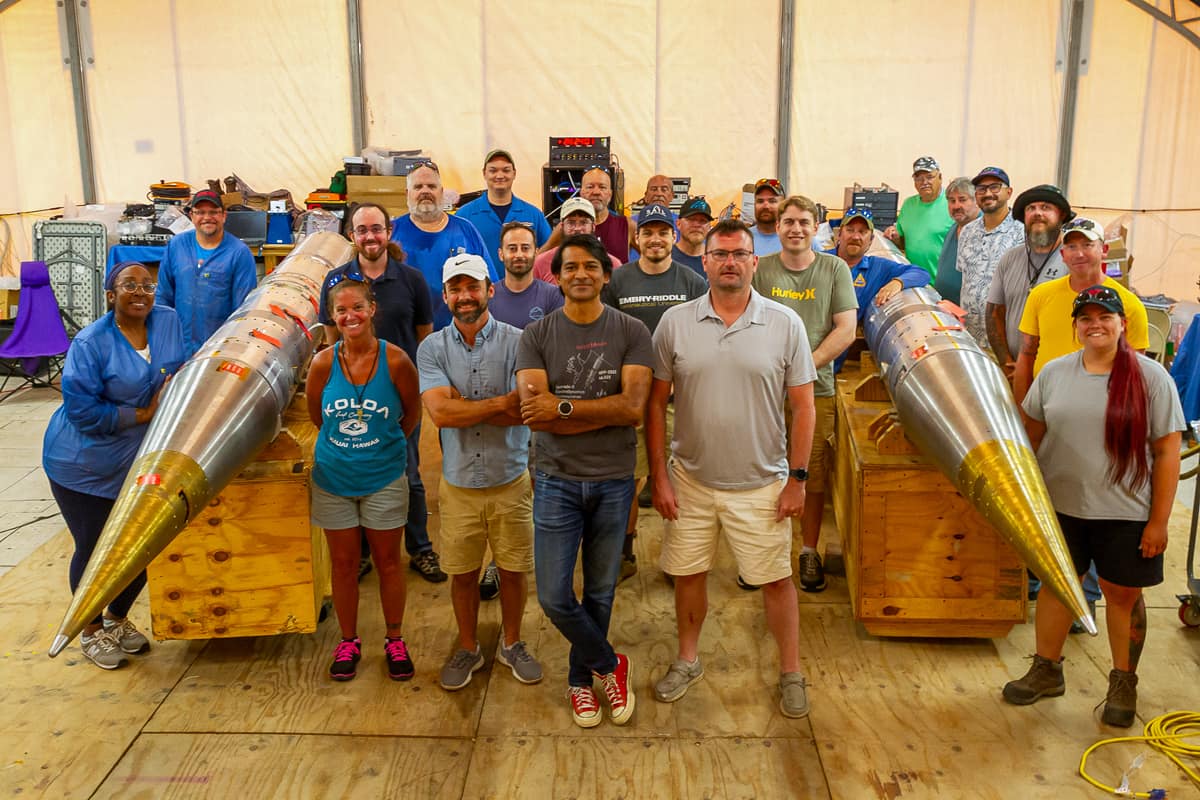 The Embry‑Riddle and NASA field team with fully assembled, instrumented payloads for the SEED rockets within the Payload Assembly Tent on Kwajalein Atoll. (Photo: Chris Lanier/NASA)