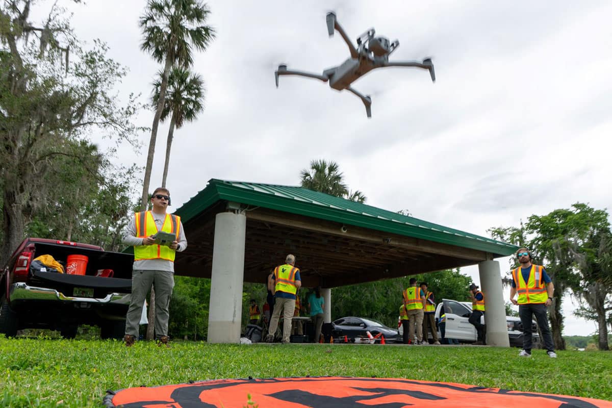 Embry‑Riddle student Nicholas Buckalew launches a Skydio UAV for a research project to survey plant life on Lake Beresford in DeLand, Florida. The research, conducted with Stetson University’s Institute of Water and Environmental Resilience, will help to understand the health of the lake. (Photo: Embry‑Riddle/David Massey)