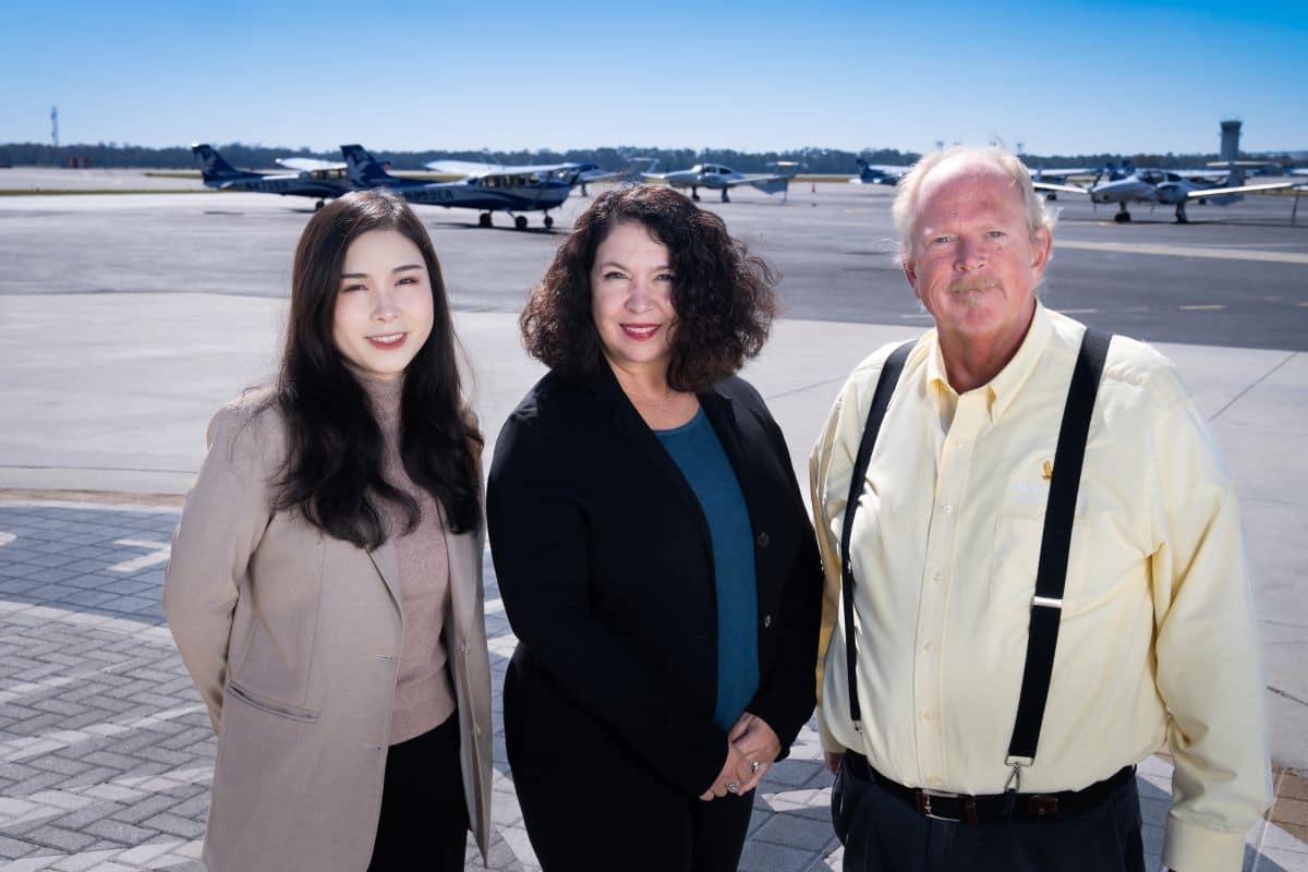 Backed by a $1 million Federal Aviation Administration (FAA) grant, Embry‑Riddle Aeronautical University Presidential Fellow Dr. Barbara Holder (center) is working to develop more effective training programs that integrate pilots’ technical skills, such as operating aircraft controls, and non-technical skills, like decision-making and other skills traditionally called Crew Resource Management (CRM). Dr. David A. Esser (right), a professor in the Department of Aeronautical Science, and Aviation Ph.D. student Hui (Angel) Wang (left), are also working with Holder on the project. (Photo: Embry‑Riddle/Bernard Wilchusky)