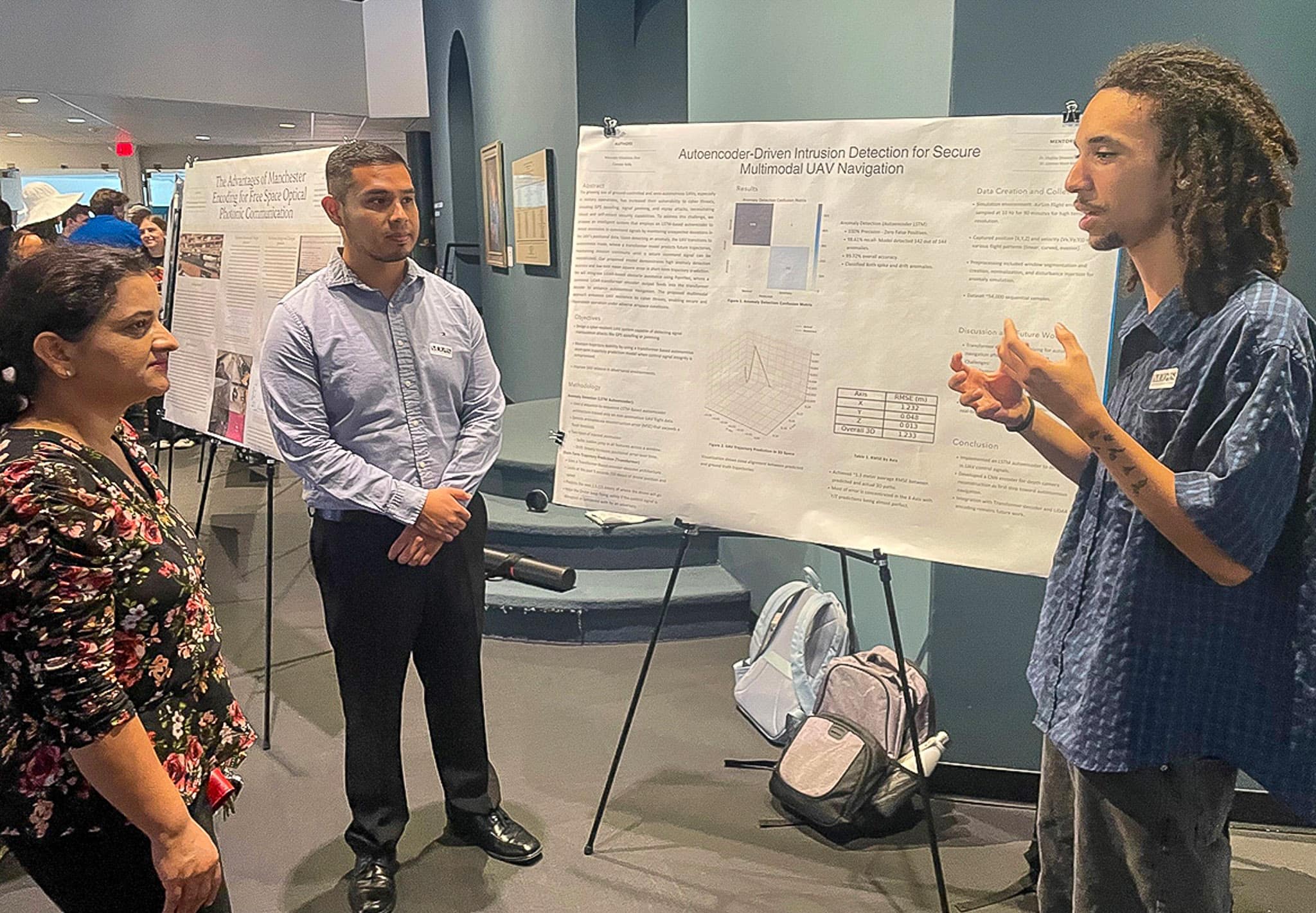 Connor Kelly presents his UAV cybersecurity research to Dr. Kandel in a poster session at the Embry‑Riddle Undergraduate Research Showcase at the Museum of Arts and Sciences in July. (Photo: Embry‑Riddle/ Melanie Stawicki Azam)