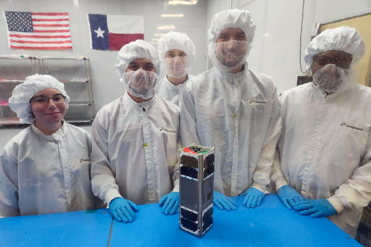 An Embry‑Riddle team prepares to integrate the student-built CubeSat EagleSat-2 into a deployer. EagleSat-2 is scheduled to hitch a ride to space aboard a Northrop Grumman rocket this fall. (Photo: Embry‑Riddle)