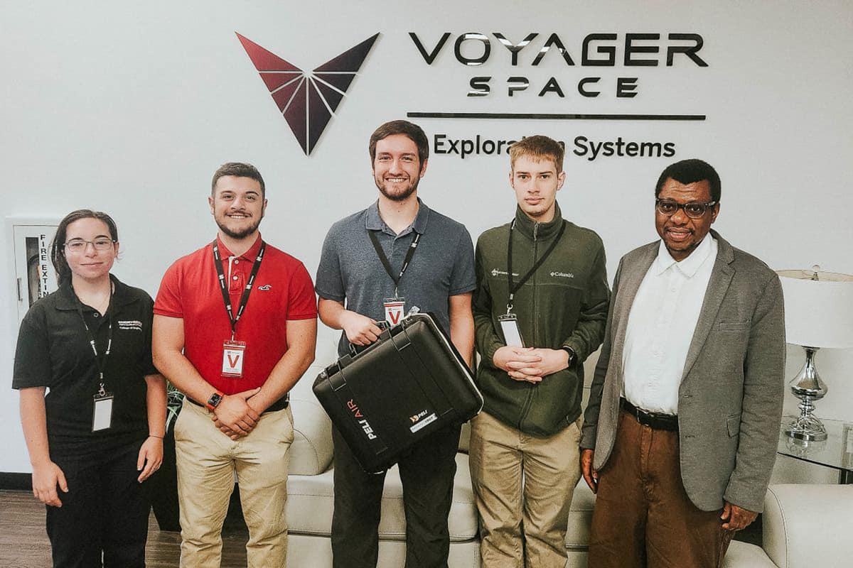 The EagleSat-2 team, which includes students Ela Ozatay, Jimi Wadnola, Bruce Noble, Gary Wiens and faculty mentor Dr. Ahmed Iyanda Sulyman, visits Voyager Technologies in Webster, Texas. (Photo: Embry‑Riddle)