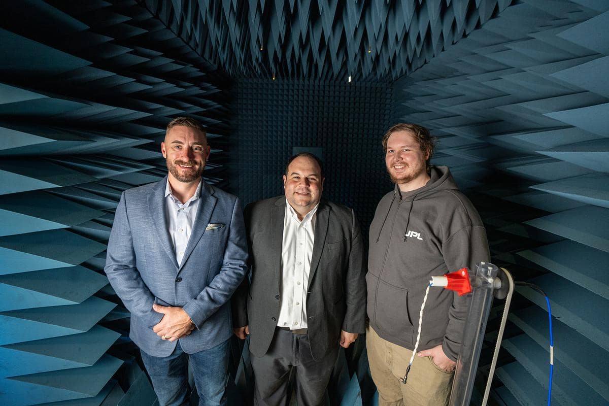 Ryan Clayton, Dr. Eduardo Rojas-Nastrucci and Blake Roberts pose inside of the WiDE Lab’s Anechoic Chamber at Embry‑Riddle's MicaPlex. (Photo: Embry‑Riddle/David Massey)
