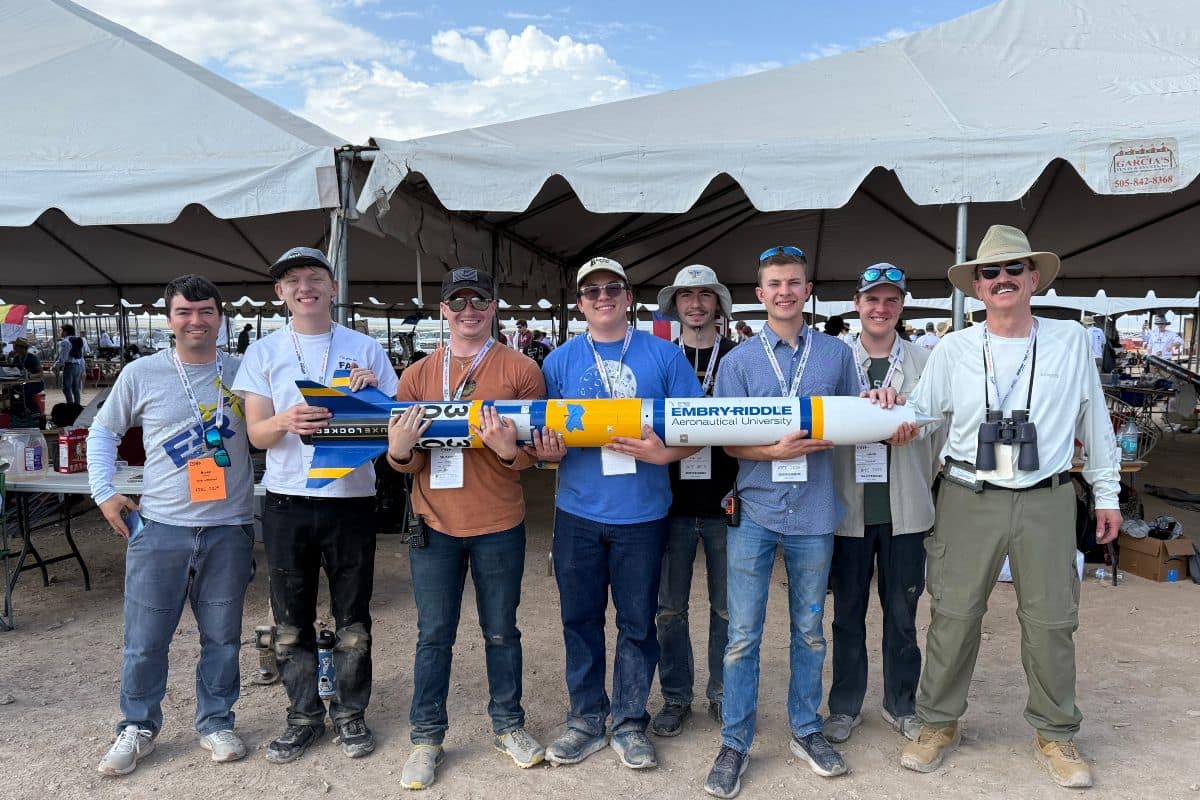 Team members from Embry‑Riddle’s Rocket Development Lab at the International Rocket Engineering Competition (IREC) in Midland, Texas. Holding the team’s rocket (from left to right) are: alumnus Bryce Chanes (’18); students Quentin Trull, Shea Schmidt, Chase Ahrens, Kevin Wise, Ben Lambertson, Calvin Lindemann; and Professor Mark Benton, the team’s faculty advisor. (Photo: Embry‑Riddle)