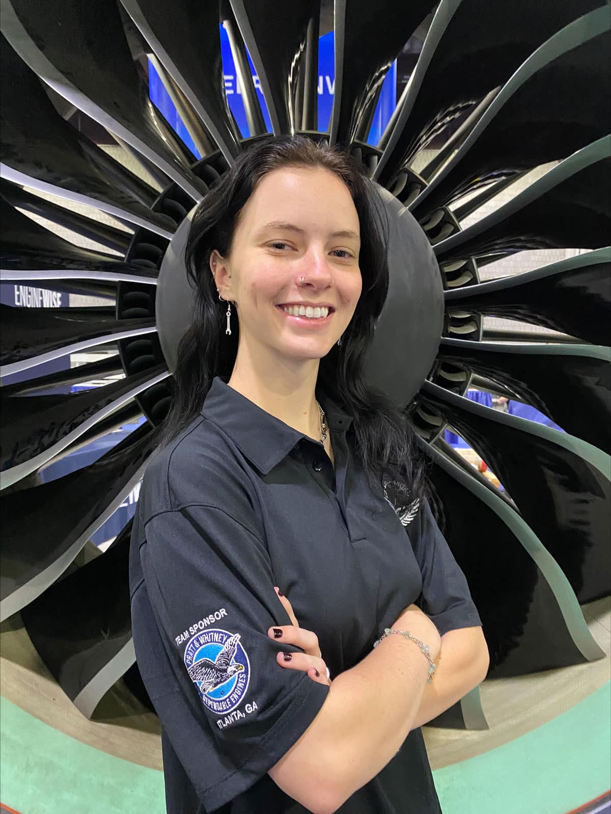 Posing in front of a turbo fan engine, Shelby Quillinan is all smiles as she contemplates her future as an aviation maintenance technician. (Photo: Shelby Quillinan)
