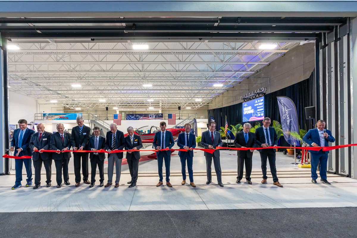 A ribbon-cutting ceremony is held to celebrate the grand opening of AURA AERO's facility.