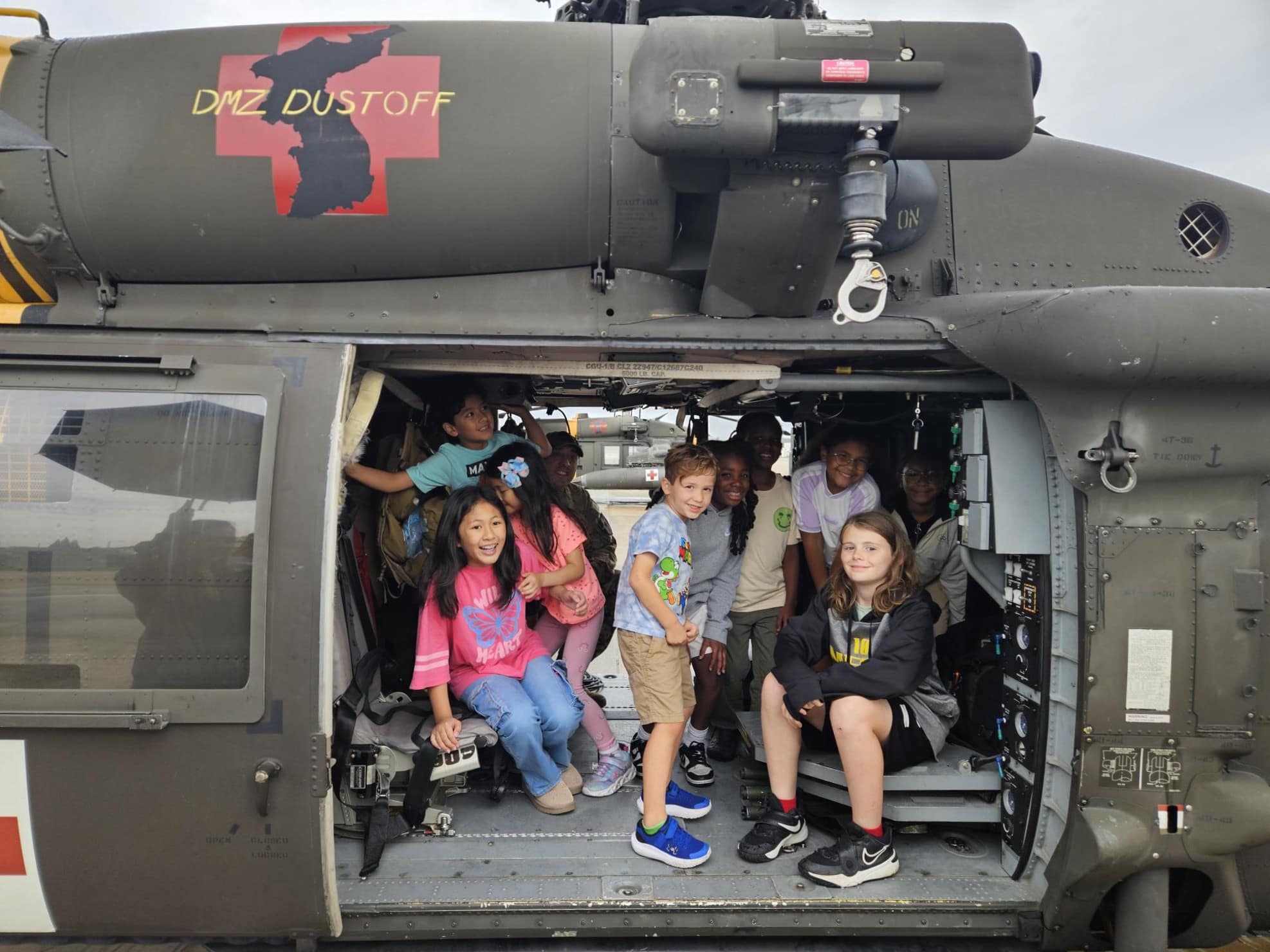 Military children on a UH-60 Blackhawk.