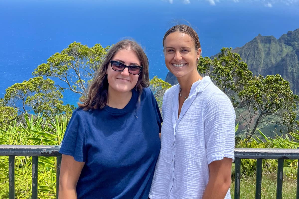 Embry-Riddle studnets Amanda Wills (left) and Kailea Danielson pose for a photo overklooking Kauaʻi’s Nāpali Coast.