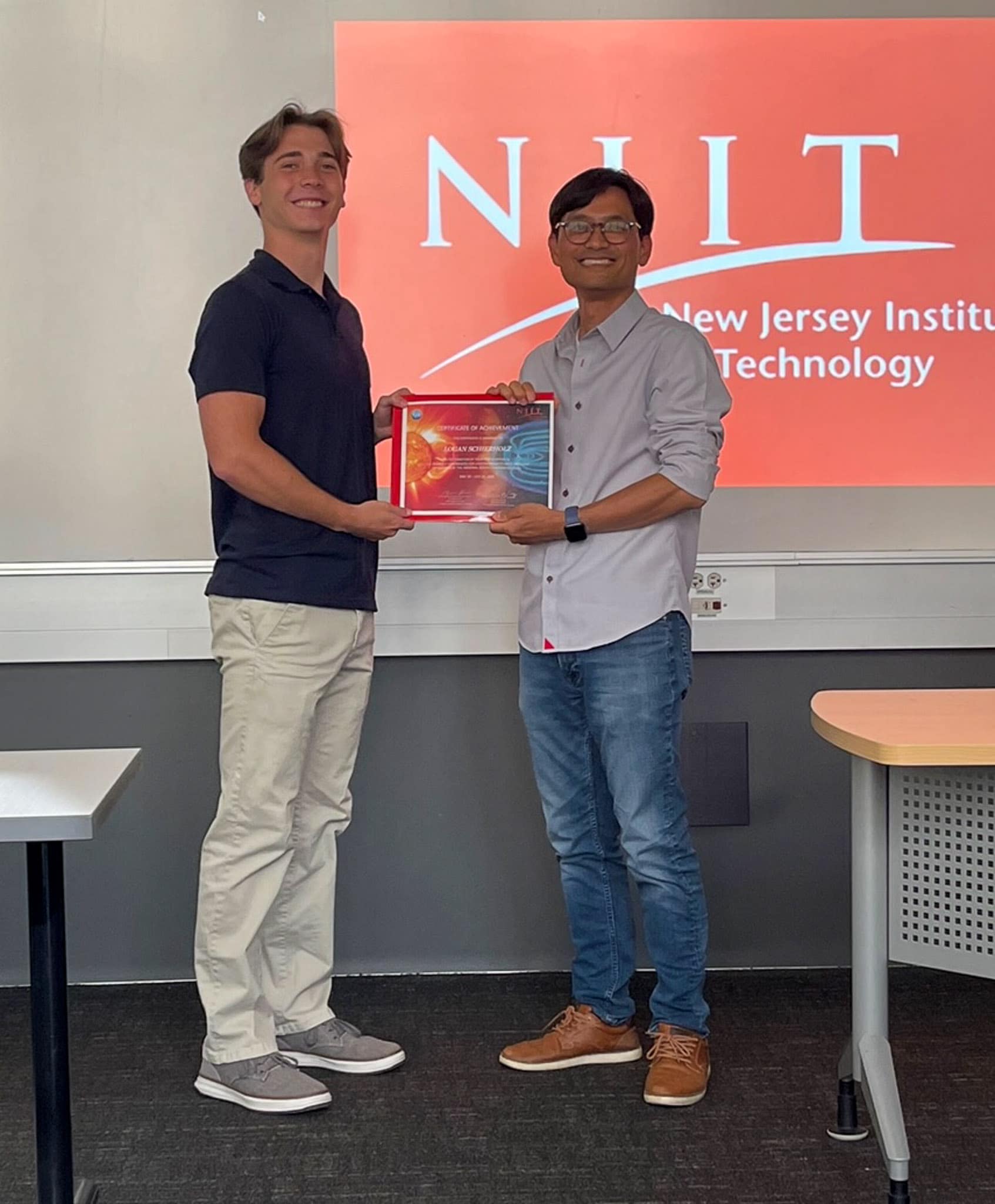 Logan Schierholz accepts certificate.
