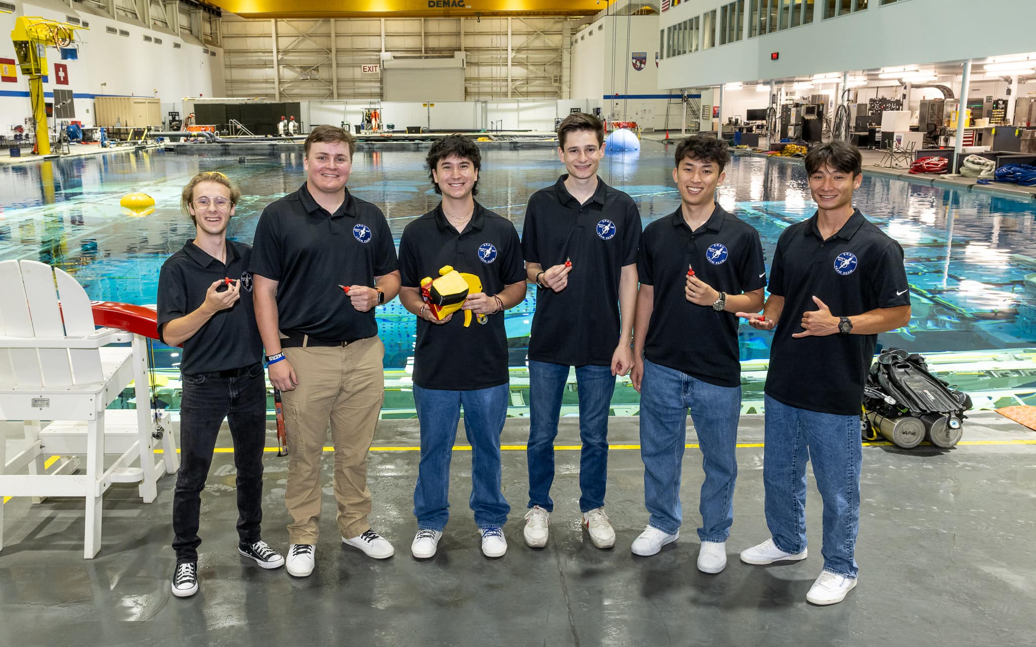 Team SEAM poses with their soft goods solution at Neutral Buoyancy Laboratory in Houston, Texas. (Photo: Embry‑Riddle/Bill Stafford)