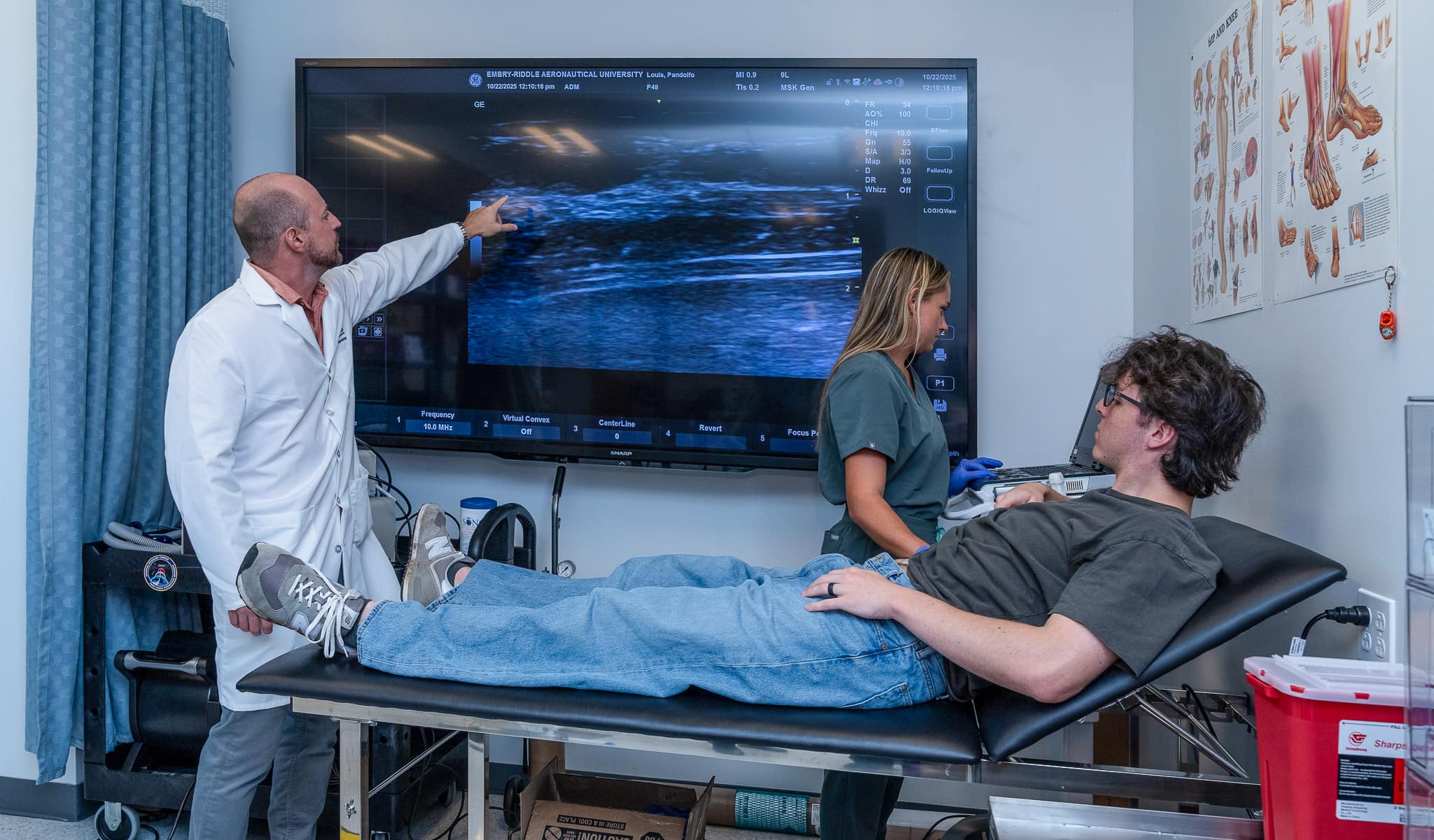 Dr. Scott Ferguson and Ph.D. candidate Sabrina Ehrenfort check the diaphragm thickness of a participant using Doppler ultrasound.