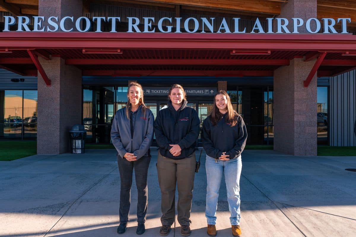 Embry-Riddle alumni (from left) Julia Metivier ('20), Sydney Webb ('25) and Dakota Bernier ('25) are bridging the gap between classroom and workplace in their roles at Prescott's airport, Ernest A. Love Field.