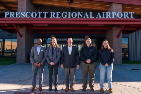 Department Chair and Associate Professor of Air Transport Economics Dr. Jules Yimga (left) reunites with three former students who now work at the Prescott airport. Here, they are alongside him and Airport Director Rick Crider, A.A.E. (center).