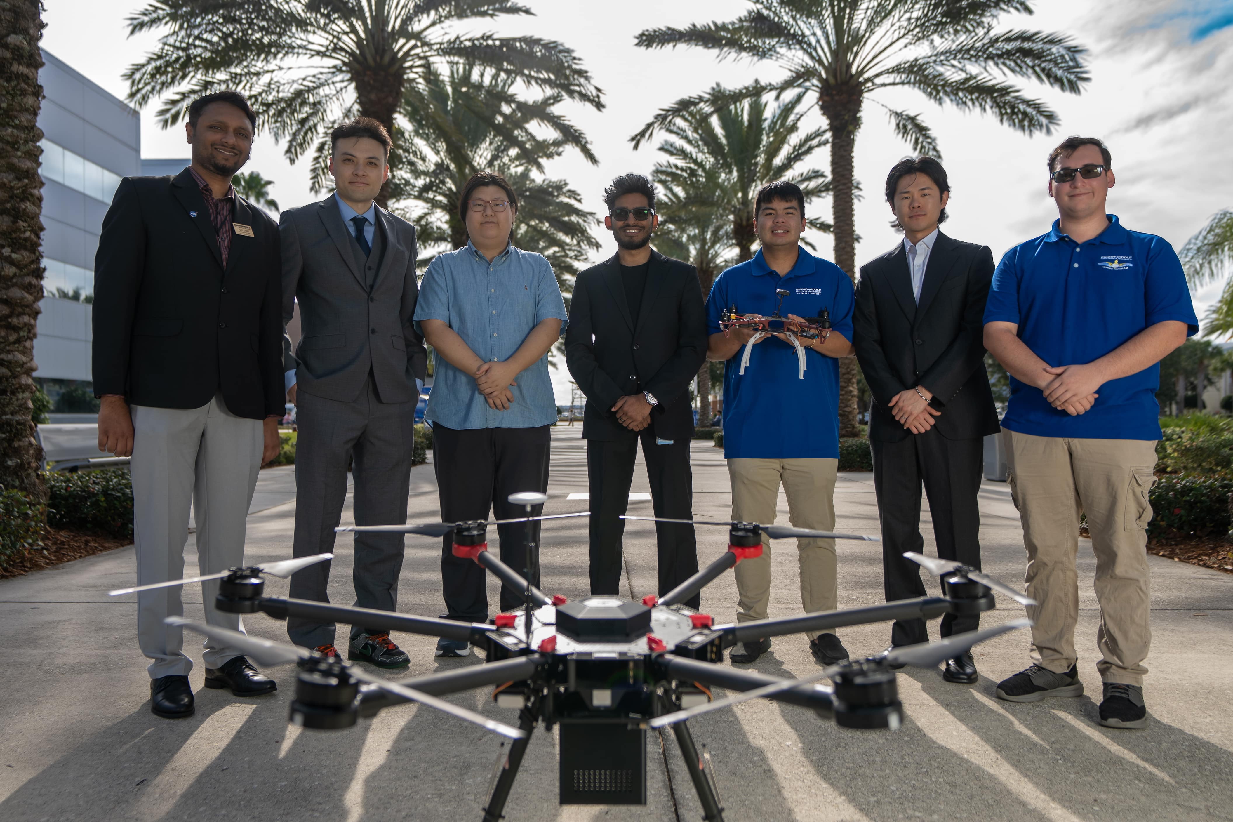  Joel Samu, Dr. Chuyang Yang, Chin Yong ”Alex” Chung, Arjun Nambiar, Isaiah Vahos, Juin Park and James Deal stand behind drone.